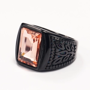 Macro shot of stainless steel ring featuring a rectangular pink gemstone with side cutouts