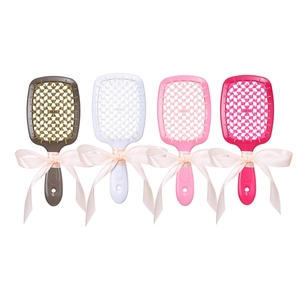 Set of four hollow scented hairbrushes in brown, white, pink and rose with ribbon bows