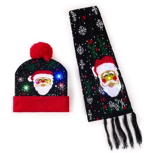 Detail of LED light-up knitted Christmas hat and scarf set with Santa Claus and snowflake motifs
