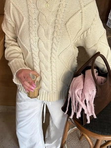 Women's cream white cable knit sweater featuring a cozy crew neck and long sleeves