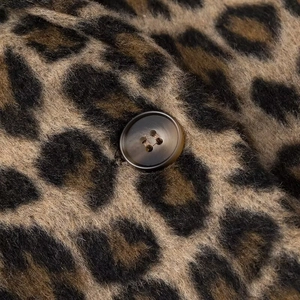 Vintage leopard print wool blazer for women with textured fabric and button detail