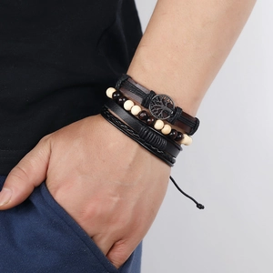 Close-up of multilayer leather bracelet set with beads and life tree metal charm