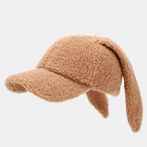 Close-up of caramel lamb wool baseball cap with cute long rabbit ears and soft texture