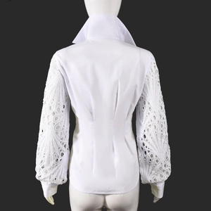 Rear view of white shirt with intricate lace puffy sleeves and slimming waist detail