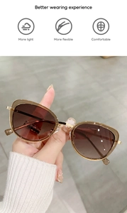 Macro shot of sleek gold metal frames with gradient brown cat eye sunglasses lenses