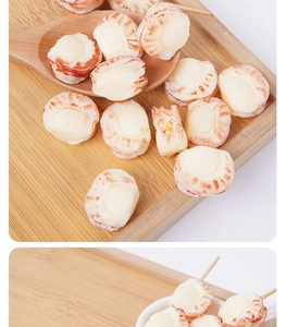 Close-up of PVC artificial scallop meat on wooden skewer and tray for kitchen play food