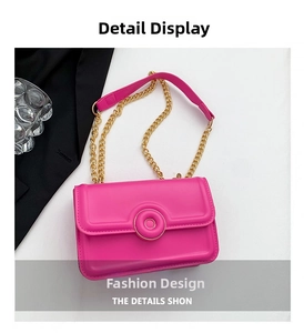 Detailed macro view of the rose red glossy leather handbag with gold chain strap
