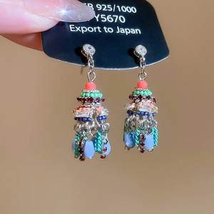 Detail view of luxury satin teardrop earrings with crystals and silver needle studs