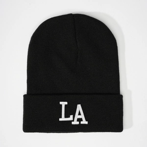 Close-up of the detailed white LA 3D embroidery on the black ribbed knit beanie hat