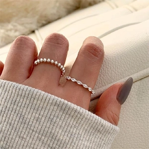 Detail of 925 sterling silver beaded ring set with marquise cut zircon on model hand