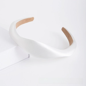 Detail of white sponge padded headband with non-slip brown lining and leather texture