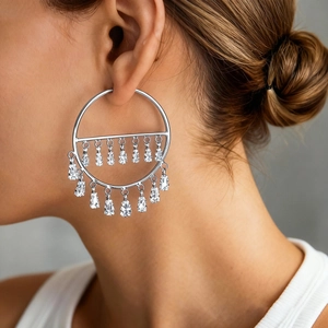 Macro side view of silver drop fringe earrings with zircon tassels on a model