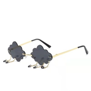 Detail of cloud-shaped rimless sunglasses with dangling charms and gold metal temples