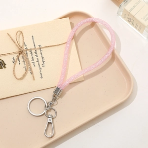 Detail of glitter mesh rope phone charm keychain with silver ring and lobster clasp