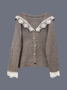 Dettaglio cardigan in maglia marrone con colletto in pizzo e bottoni metallici