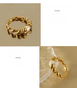 Detail of twisted 18k gold plated stainless steel ring featuring a white natural pearl