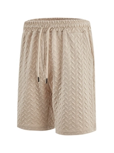 Detail of beige jacquard chevron texture and elastic drawstring on men's beach shorts