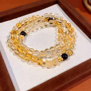 Bracciale a tre strati in perle di citrino con dettagli neri e ciondoli dorati