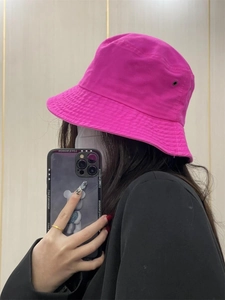 Detail of bright pink cotton bucket hat with sun protection for street style outfits