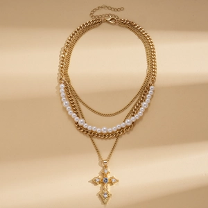 Elegant layered vintage necklace with pearls, rhinestones, and cross pendant in gold finish