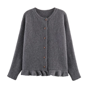 Detail of dark grey knit cardigan featuring wooden buttons and ruffled wavy hemline