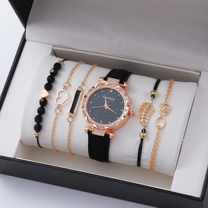 Close-up of women's quartz watch and five beaded bracelets in a black gift box