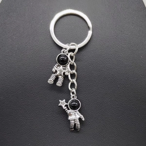 Vintage astronaut keychain in antique silver with star pendant and black helmet beads