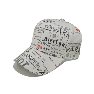 Close-up of street style baseball cap with black and red graffiti print on gray fabric