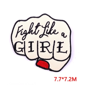 Macro shot of 7.7x7.2cm Fight Like a GIRL embroidered fist patch with red nail polish detail