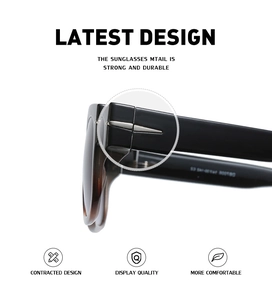 Detailed close-up of metal arrow decoration and hinge on black oversized sunglasses