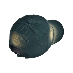 Detail view of washed dark green baseball cap with vintage distressed finish and back strap