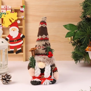Detailed view of plush Christmas gnome with braided beard and knitted snowflake hat