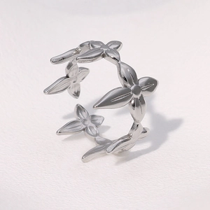 Macro shot of silver adjustable ring featuring continuous pointed petal flower pattern