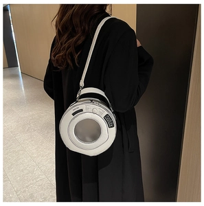 Detail of creative white washing machine shaped handbag featuring a round clear window