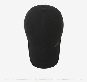 Top down view of black winter baseball cap with fine knit texture and metal accent detail