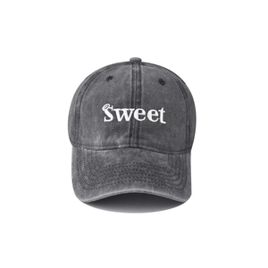 Detail of embroidered SWEET lettering on vintage washed dark grey cotton baseball cap