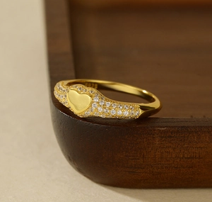 Macro shot of 925 sterling silver gold plated heart ring with micro-pave white cubic zirconia