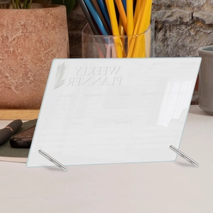 Detailed view of a clear acrylic weekly planner board on a desk with metal stands