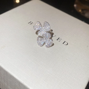 Macro detail of elegant clover leaf ear cuff with sparkling zircon inlay and silver finish