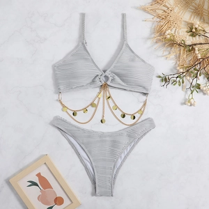 Detail of grey pleated bikini featuring layered gold metal chains and circular sequins