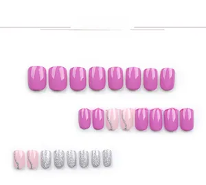 Detail view of short square press-on nails in magenta, pale pink, and silver glitter