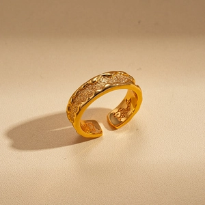 Macro shot of 24k gold plated ring featuring inner koi fish engraving and sandblasted finish