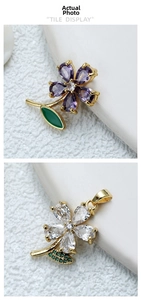 Close-up of 18k gold rose pendants with purple gems and white zircon flower petals