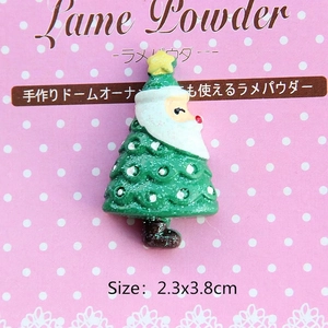 Macro view of Santa and Christmas tree resin charm with glitter and 2.3x3.8cm size