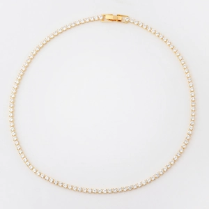 Close-up of gold-plated tennis necklace with round cubic zirconia and fold-over clasp