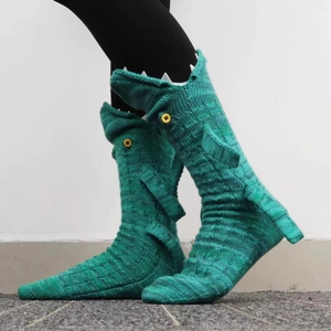 Detail of knitted shark socks with realistic fins, tail, and sawtooth teeth details