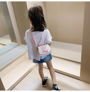 Pink bow girl crossbody bag with rabbit ears and diamond lattice texture on shoulder