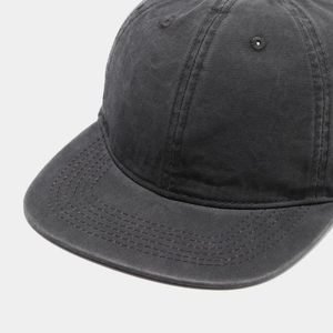 Close-up of charcoal grey washed cotton twill fabric on a vintage baseball cap