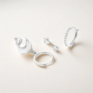 Macro detail of S925 sterling silver earring set with pearl, zircon, and hallmarked post