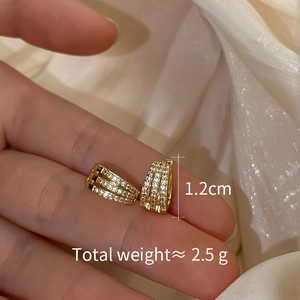 Detail view of gold zircon hoop earrings with 1.2cm size and 2.5g weight specifications
